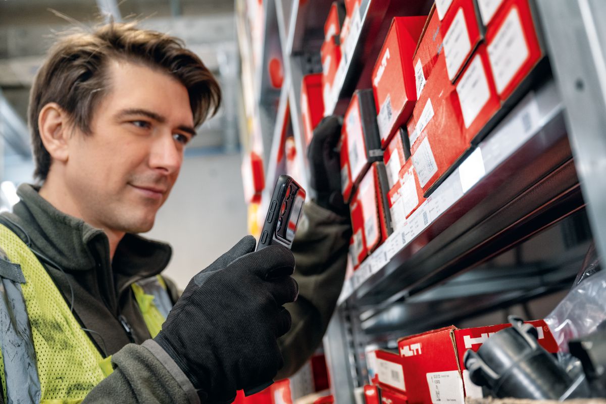 Image of a worker checking the ON!Track app to sync up his inventory and invoices for the consumables management CiaB campaign