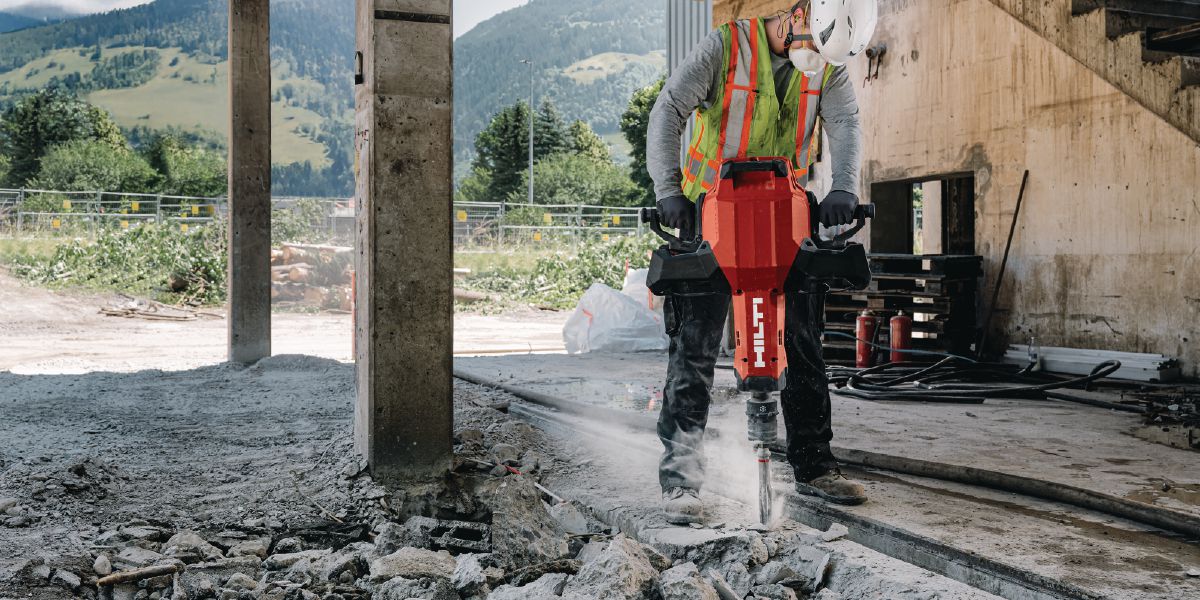 Cropped application image of cordless breaker TE 3000-22 channeling with flat point chisel.