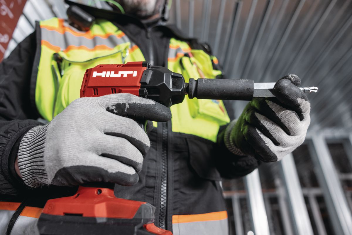 Application Image - worker attaching the KH-EZ IQ push-to-connect screw anchor to the SIW 6AT impact wrench