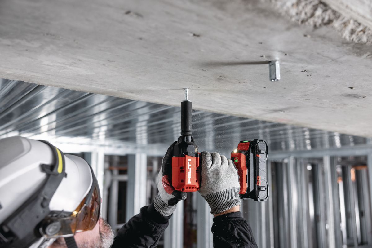 Application Image - worker installing KH EZ IQ push-to-connect screw anchor