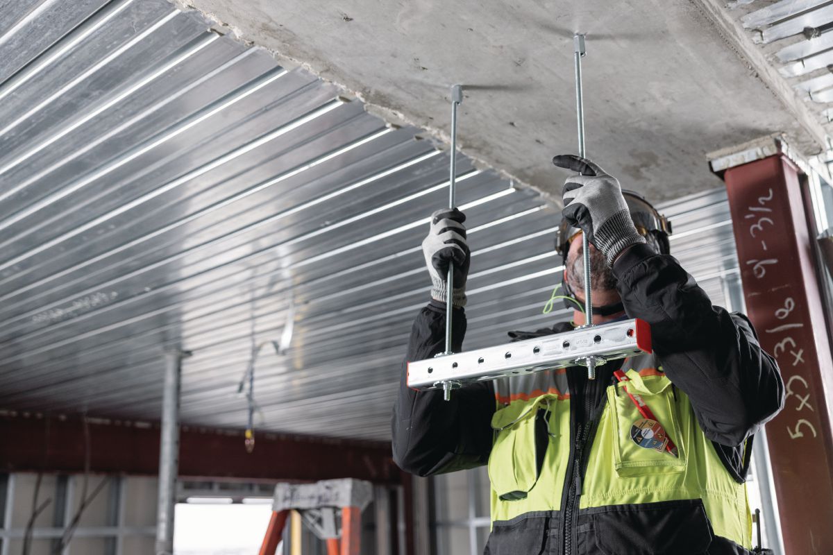 Application Image - worker installing hanging rods into KH-EZ IQ push-to-connect anchors